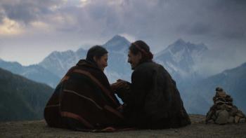 Tenzing: Young man and woman in the shadow of the Himalayas.