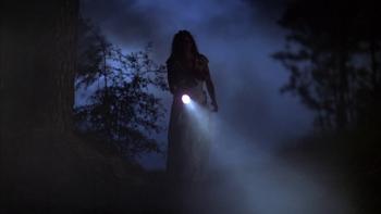 Texas Chainsaw Massacre—The New Generation: Silhouetted person with flashlight in dark, misty forest