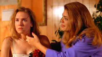 Texas Chainsaw Massacre—The New Generation: A woman leans over and touches the side of a frightened woman’s face