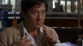 The Accidental Spy: Jackie Chan sits holds handkerchief and crucifix