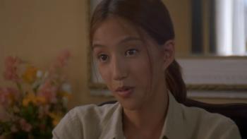 The Accidental Spy: Min Kim sits in chair