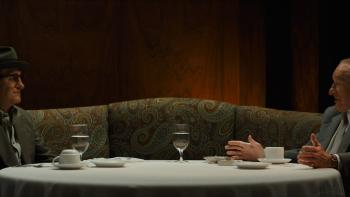 The Alto Knights movie: Robert De Niro and Frank Costello sit across from each other at a table