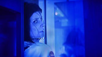 The Astronaut movie: Close-up of Kate Mara's face looking on guard as she peers around a corner, her back to the wall