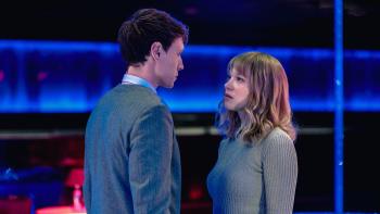 The Beast: George MacKay and Léa Seydoux stand staring at each other against a futuristic blue backdrop
