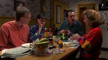 The Castle: A White family of four sit together at a dinner table eating