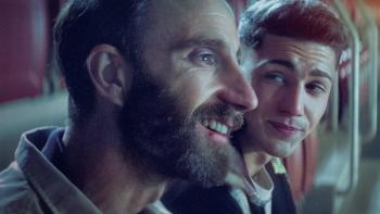 The Champion movie: Spanish bearded man smiles left next to Spanish man behind him right