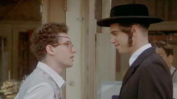 The Chosen: A young Jewish teen stands talking to a young Orthodox Jewish teen outside of a building