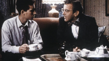 The Chosen: A young Jewish teen talks to his father on the couch inside a sitting room