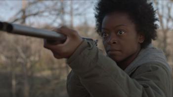 The Devil to Pay movie: outside a Black woman on right points a shot gun at someone off camera