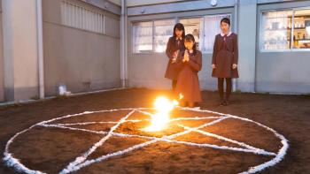 The Divine Protector - Master Salt Begins movie screenshot 2: Three teen girls pray towards a pentagram circle with a letter burning in center.