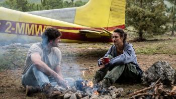 The Dog Stars movie: Jacob Elordi and Margaret Qualley sit next to a campfire near a small plane in a field