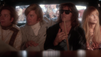 The Doors movie: Three band members of the Doors plus Pam sit inside a car in the backseat