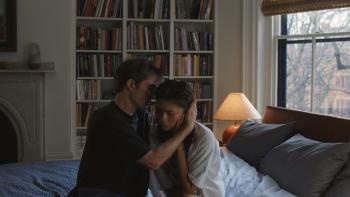 The Drama movie: Robert Pattison holds Zendaya close on a sofa, whispering in one ear while covering the other