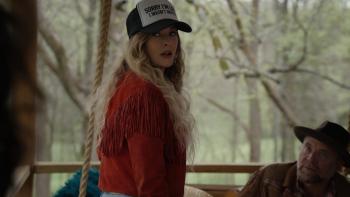 The Easy Kind movie: Singer Elizabeth Cook, in a cap and fringe jacket, stands outdoors; a man in hat sits nearby