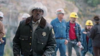The Faith of Angels: A sheriff stands in front of search and rescue workers