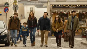 The Family Plan 2: Family walks down street.