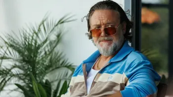 The Get Out: Man in sunglasses and tracksuit, sitting outdoors, with plants nearby