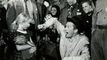 The Juggler: Kirk Douglas entertains a child at a refugee camp