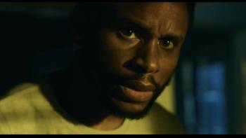 The Knife movie: Nnamdi Asomugha looks with concern around the corner of his house in the middle of the night