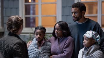 The Knife movie: A Black family of four huddles together outside their house at night talking to a police detective