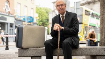 The Last Rifleman Movie: Pierce Brosnan as a World War II veteran sits on a bench.