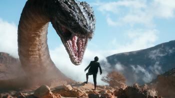 The Magic Flute Movie: A giant snake dragon looms over a teen boy, hissing and showing its fangs