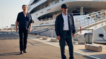 The Marked Woman: Two men by a yacht.