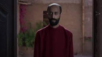 The Matchmaker: Bearded Saudi man in long red shirt center stands in doorway