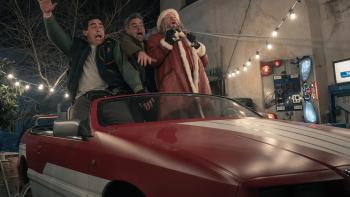 The Night My Dad Saved Christmas 2: Santa stands in a red car working as a sleigh with surprised looks on their faces