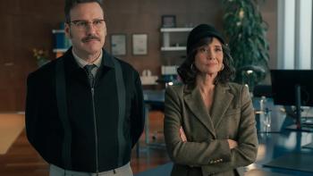 The Night My Dad Saved Christmas 2: A man and a woman stand side by side with serious looks on their faces