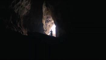 The Odyssey movie: A dark cave with a soldier depicted in the distance