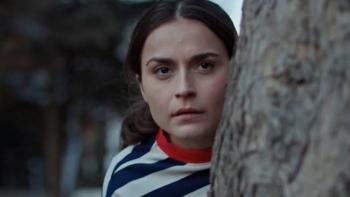 The Paradise Murders: Kayla Raelle leaning on a tree