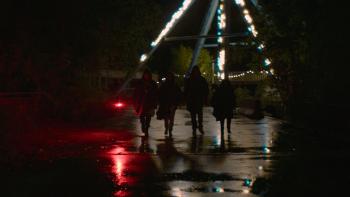 The Park: Four silhouettes of kids at night walk toward camera in a theme park.