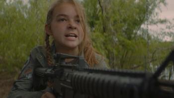 The Park: White girl center with automatic rifle faces camera snarling.