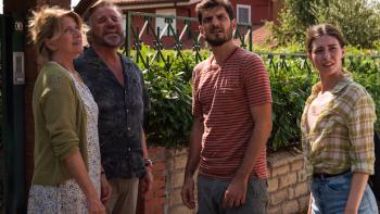 The Price of Family: The family of four outside their home.