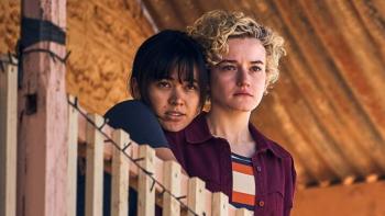 The Royal Hotel: Liv puts her arms around a concerned looking Hanna as they look out from their balcony.