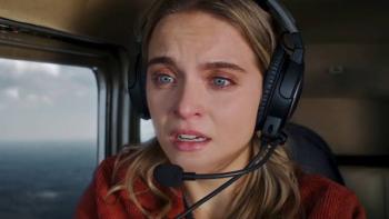 The Seemingly Perfect Family: Woman with headset looks emotional in a helicopter.
