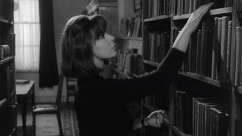 The Spy Who Came in from the Cold: A young White woman puts book on shelf