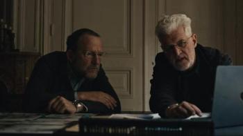The Stringer: The Man Who Took the Photo movie: White man with glasses and short hair left, White man with white hair and glasses right, sit at desk