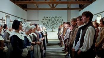 The Testament of Ann Lee movie: Shakers line up, women facing men, with the Shaker drawing of a tree centered on the wall between 