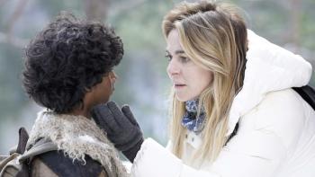 The Tiger's Nest: A young blond woman holds her hand next to a young Indian boy’s cheek as she looks at him kindly.