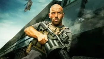 The Wages of Fear movie: French white man center leans against large truck with grenade launcher as helicopter flies above