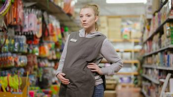 The Wasp Movie: Natalie Dormer stands between market aisles, holding her pregnant belly