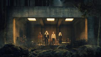 The Watchers Movie: Four people stare out of a large glass window