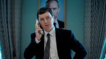 The Wizard of the Kremlin: Man in suit on phone in office with portrait backdrop