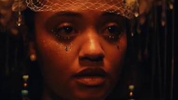 The Young Wife Movie: Kiersey Clemons, wearing glittery makeup and jewelry, looks resigned