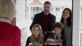 The Family Holiday: A family of four is at the door of a white-haired woman