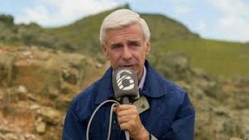 The Man Who Loved UFOs: Man with microphone outside by mountain