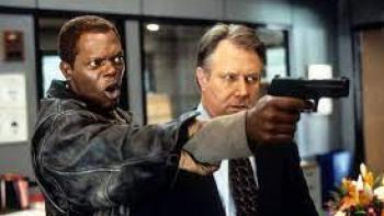 The Negotiator: Two men aim a gun at an unseen person