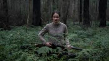The Nightingale: Aisling Franciosi runs through forest with gun